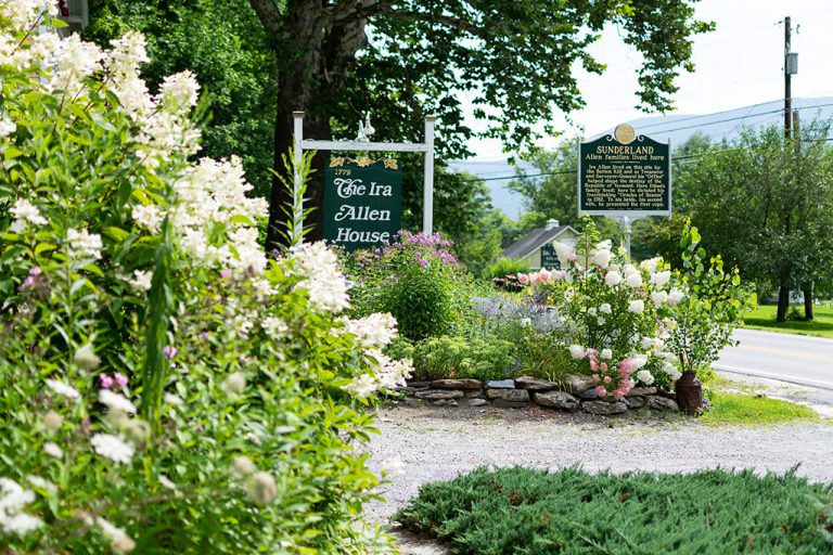 Ira Allen House flower gardens and sign in summer
