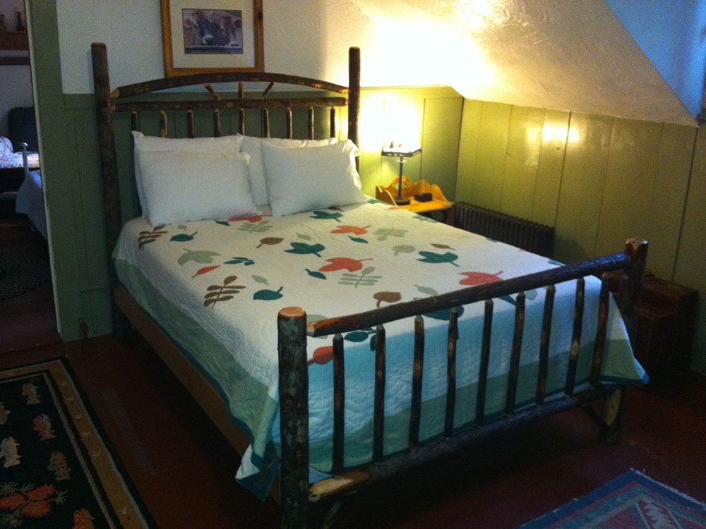Wooden Stick queen size bed in the Remember Baker Suite